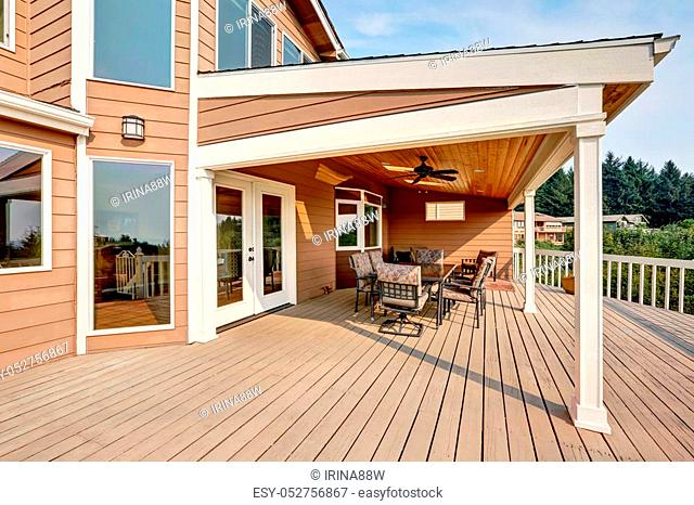 Large Wooden Walkout Deck With Flat Roof Extension And Comfortable Seating Arrangement Stock Photo Picture Low Budget Royalty Free Image Pic Esy 052756867 Agefotostock - How To Extend A Roof Over Patio