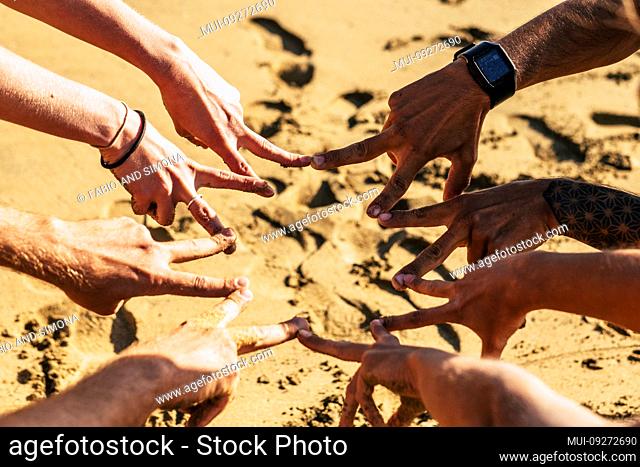 Team and cooperation friendship together concept with group of caucasian young hands doing victory sign under the sunny day of summer - friends and youthful...