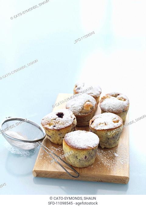 Apple and boysenberry muffins with icing sugar