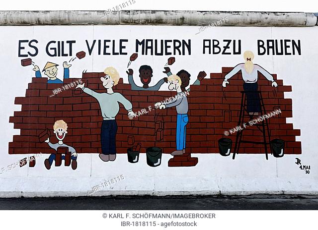 Chinese, blacks, whites, men and woman tearing down a wall together, painting on the remants of the Berlin Wall, East Side Gallery, Friedrichshain district