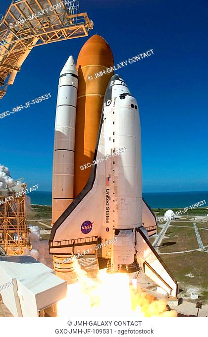 Captured on film by a remote camera equipped with a special fish-eye lens, the Space Shuttle Discovery and its seven-member STS-124 crew head toward Earth-orbit...