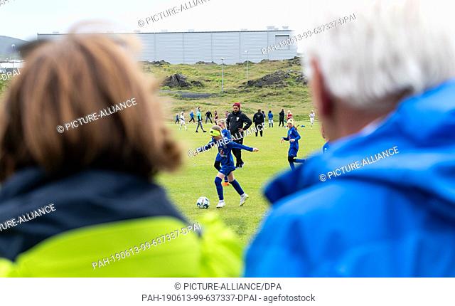 13 June 2019, Iceland, Westmännerinseln: Federal President Frank-Walter Steinmeier and his wife Elke Büdenbender visit a girls' football tournament