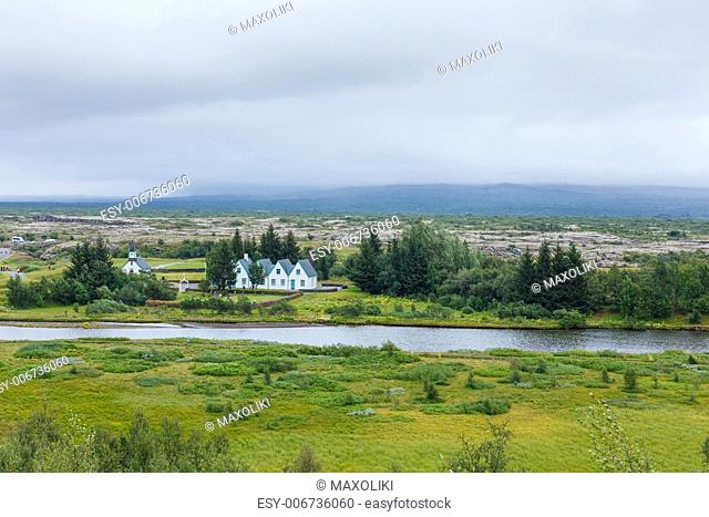 Scenic valley and a village in Thingvellir National Park - famous area in Iceland