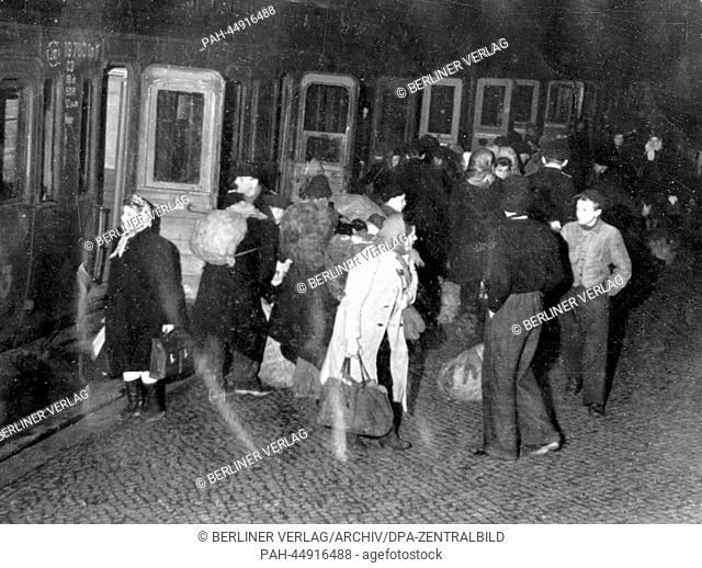 The police in the Soviet Occupation Zone check hoarders and suppliers for the black market at night at Bernau Railway Station in Berlin, Germany, January 1949