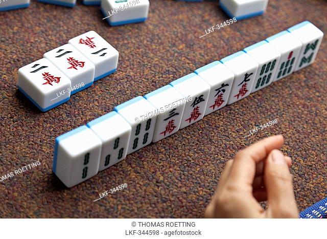 Women playing Majiang, Mahjong, Chinese board game, on the street, Chongqing, People's Republic of China