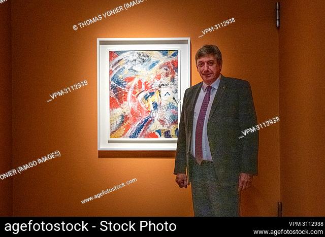 Flemish Minister President Jan Jambon poses with painting 'Ontwikkeling van een thema in Rood: Carnaval' by Belgian artist Jules Schmalzigaug at a press...