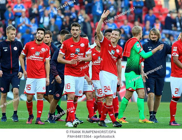 Mainz's Spieler Jhon Cordoba (l), Stefan Bell (M) and Giulio Donati (r) cheer after their 2:1 win in the match between FSV Mainz 05 and Darmstadt 98 on the...