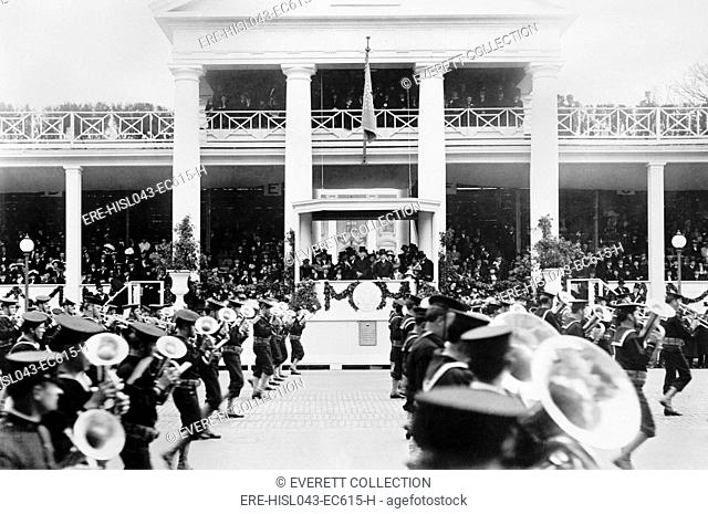President Woodrow Wilson and Vice President Marshall watch Inaugural Parade, March 4, 1913. A military band marches past the White House reviewing stand...