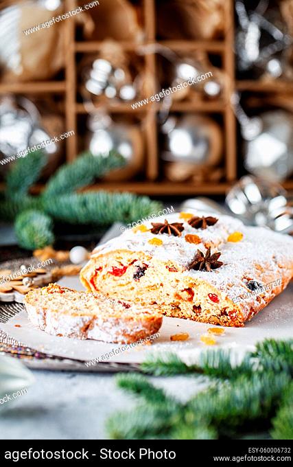 Holiday baking. Christmas cake. Stollen is fruit bread of nuts, spices, dried or candied fruit, coated with powdered sugar