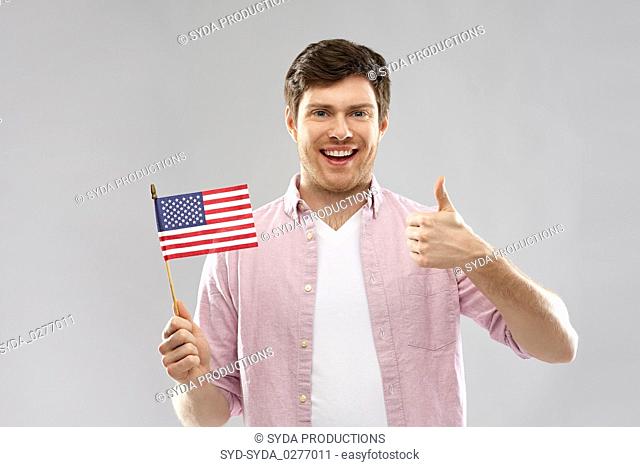 happy man with american flag showing thumbs up