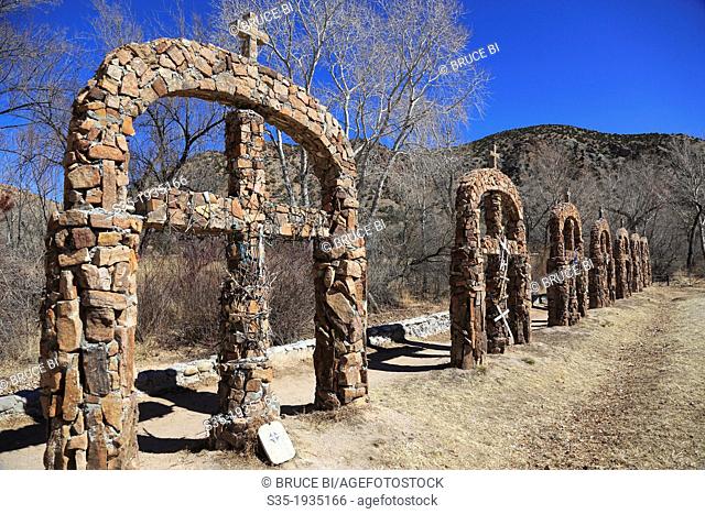 The stone crosses decorated the way to of Santuario de Nuestro Senor de Esquipulas aka El Santuario de Chimayo. Village of Chimayo. New Mexico. USA