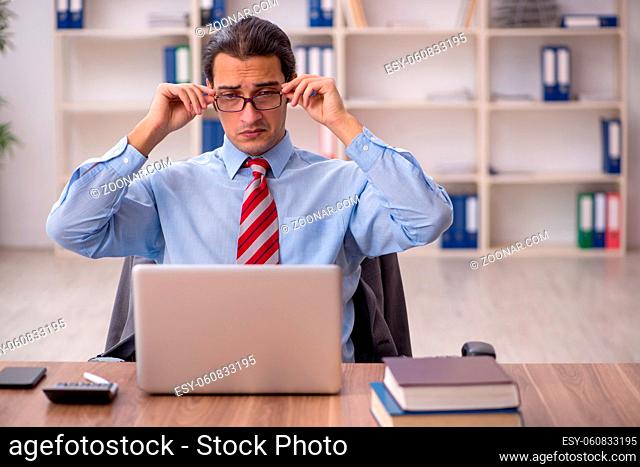 Young businessman employee sitting at workplace