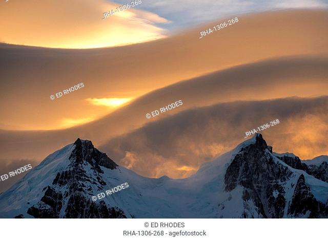 Lenticular clouds above snow covered mountain range, El Chalten, Patagonia, Argentina, South America