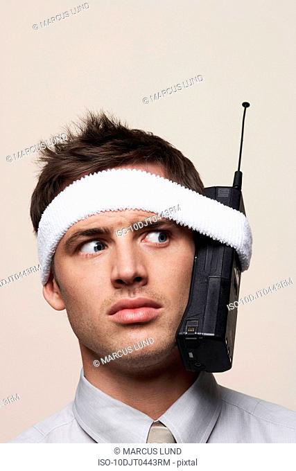 Young man with retro mobile phone