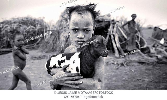 Dasanech boy with goat. South Ethiopia