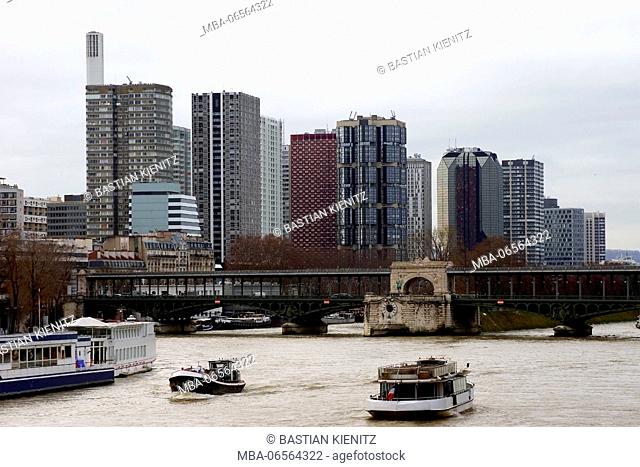 Photography of high rises, a bridge and excursion boats at the Seine