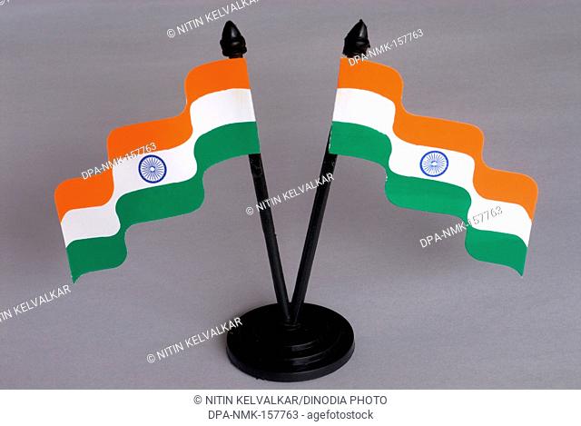 Two flying Indian tricolour ; national flag with blue Ashoka Chakra hoisted to pole ; paper material ; Borivali ; Bombay Mumbai ; Maharashtra ; India