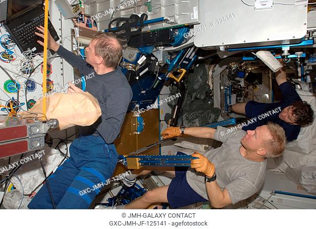 European Space Agency astronaut Frank De Winne (left), NASA astronauts Tim Kopra (foreground) and Michael Barratt, all Expedition 20 flight engineers