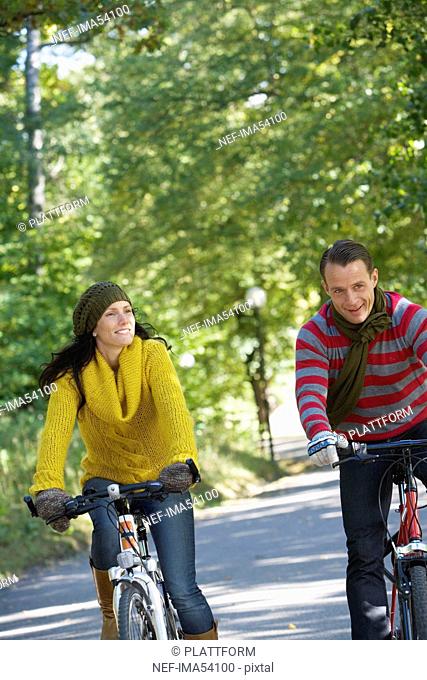 A woman and a man riding a bike an autumn day, Sweden