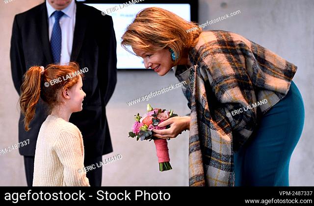 Queen Mathilde of Belgium receives flowers from a child at a royal visit to women of Flemish Brabant from different sectors at the occasion of the International...
