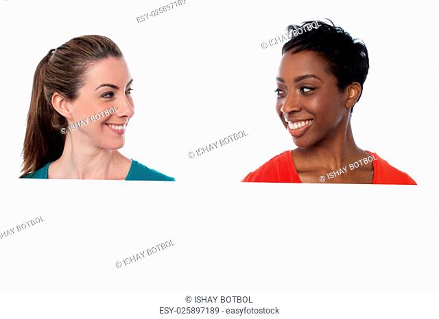 Smiling women looking at each other