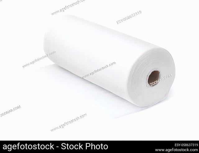 Roll of white disposable nonwoven fabric towels isolated on white