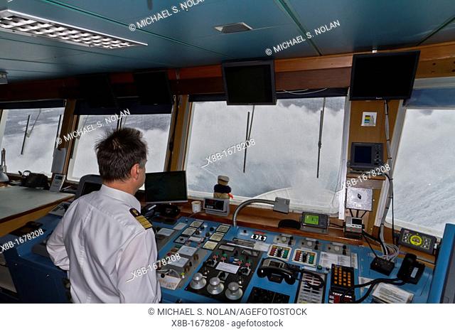 Captain Oliver Kruess on the bridge of the Lindblad Expeditions ship National Geographic Explorer in a Beaufort Scale 10 storm 35 foot seas and 50+ knot winds...
