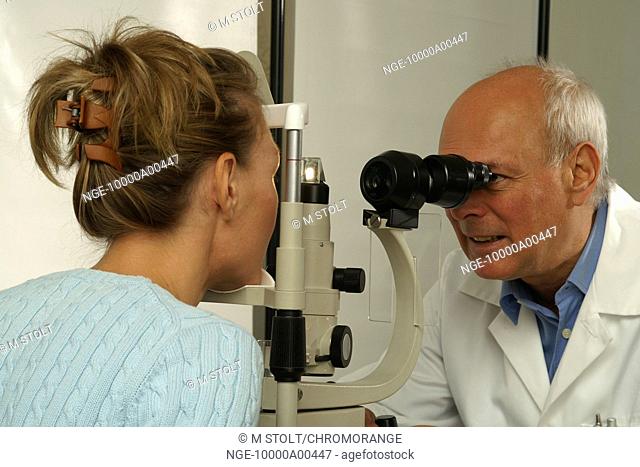 eye doctor examining patient's eyes