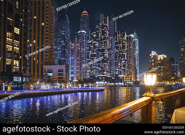 Night View Of City Skyline From Tourist Boat, Sightseeing Boat Sailing On Dubai Marina. Night Walk Of Dubai Marina Is District in Dubai, United Arab Emirates