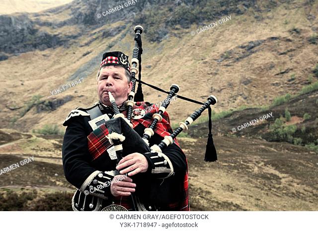 Scottish man playing the bagpipes
