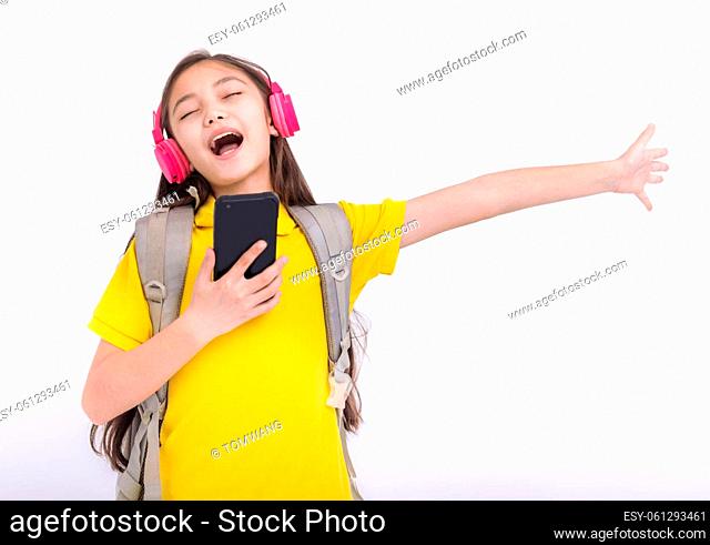 Happy student girl Listening music with headphones and sing song dancing