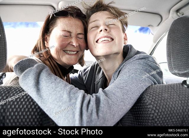 Teen boy with his mother in car, in Gaissach, Bavaria, Germany