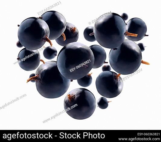 Blackcurrant berries in the shape of a heart on a white background