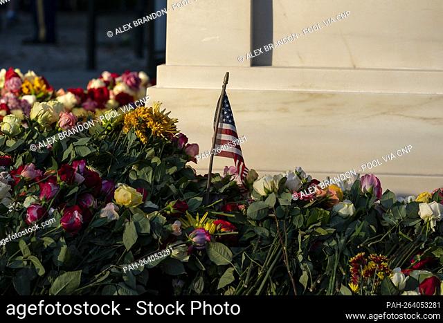 An American flag is seen amongst the flowers during a centennial commemoration event at the Tomb of the Unknown Soldier, in Arlington National Cemetery