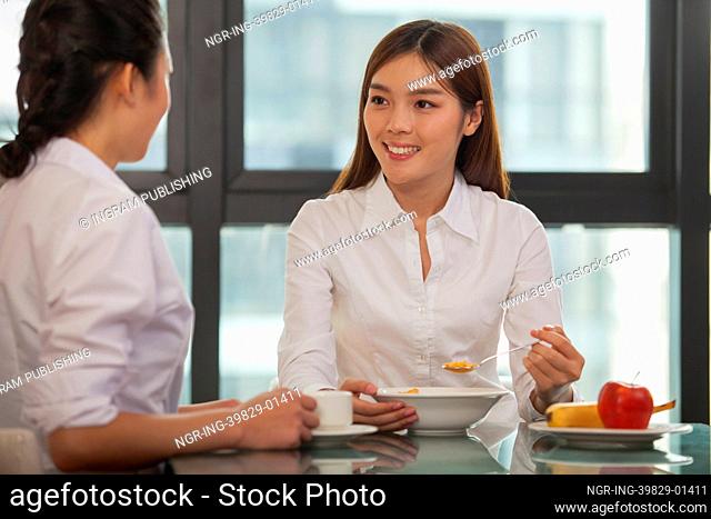 Businesswomen eating breakfast