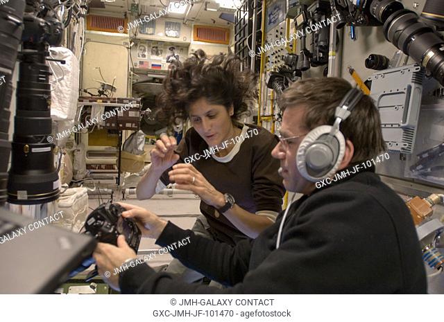 NASA astronaut Sunita Williams, Expedition 33 commander; and Russian cosmonaut Yuri Malenchenko, flight engineer, work with camera equipment in the...