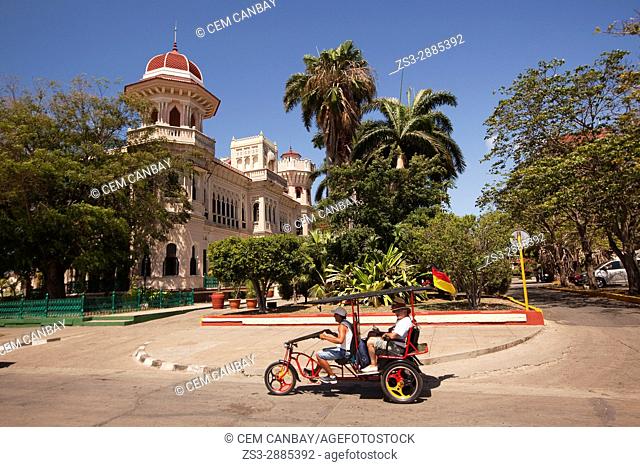Bici taxi in front of the Palacio De Valle -Valle's Palace In Punta Gorda district, Cienfuegos, Cuba, West Indies, Central America
