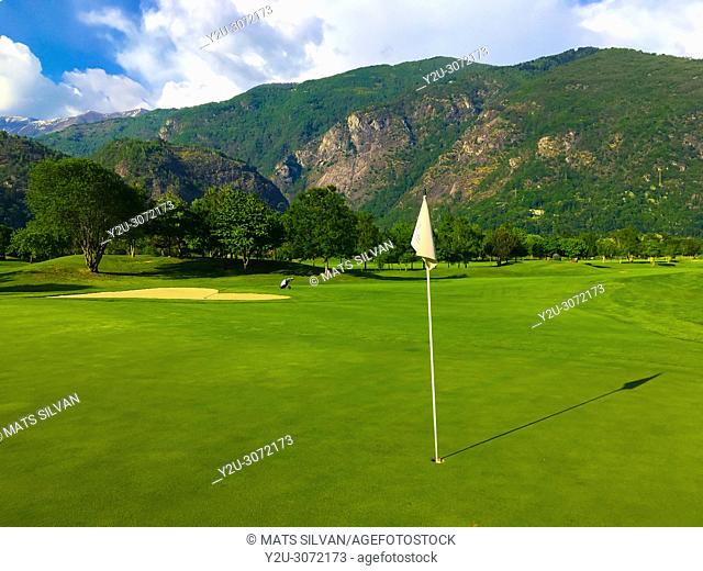Golf Course Gerre Losone with Golf Green with Flag and Mountain in Losone, Ticino, Switzerland