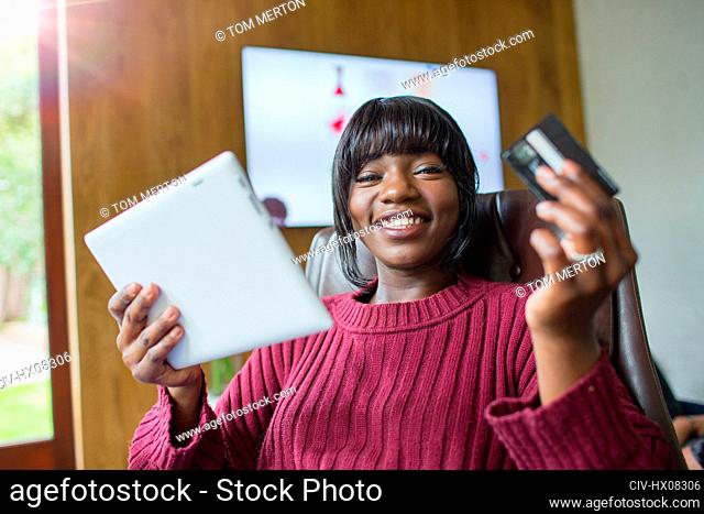 Portrait happy young woman online shopping with digital tablet