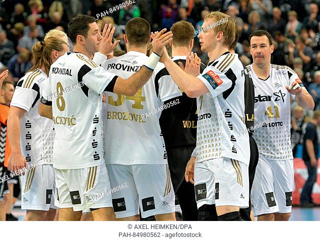 Kiel's Blazenko Lackovic (2nd l) and Rene Toft Hansen (2nd r) celebrate the victory after the Handball Champions League group phase match between THW Kiel and...