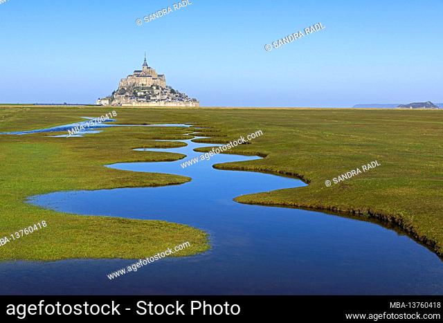 meandering watercourse in the meadows of the bay of Mont-Saint-Michel, France, Normandy, Department Manche