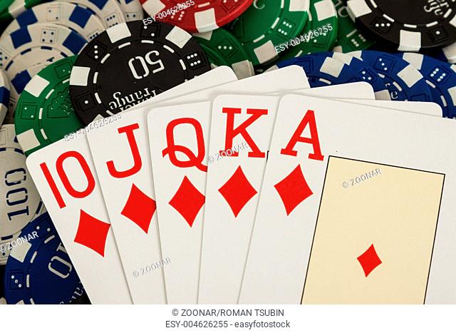 Royal flush cards over casino chips