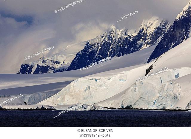 Glaciers, mountain peaks and dramatic clouds and sky, Cape Errera, Wiencke Island, Antarctic Peninsula, Antarctica, Polar Regions