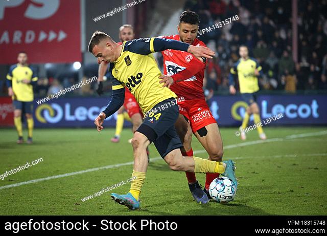 Union's Kacper Koz?owski and Kortrijk's Billel Messaoudi fight for the ball during a soccer match between KV Kortrijk and Royale Union Saint-Gilloise