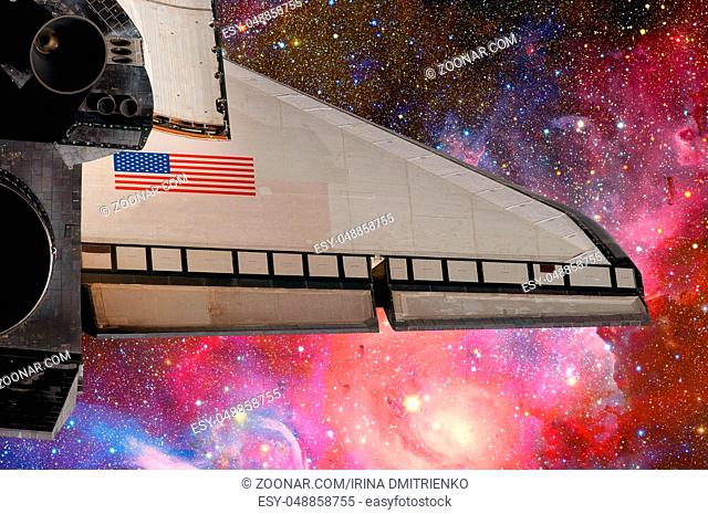Space Shuttle flight over space stars, galaxies and nebula. Elements of this image furnished by NASA