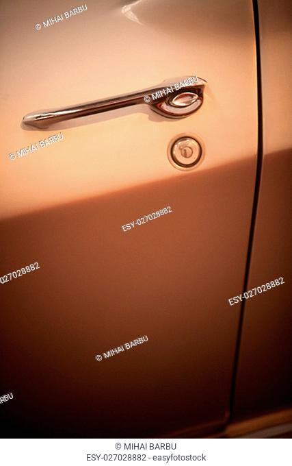 Close up shot of a vintage car's door handle
