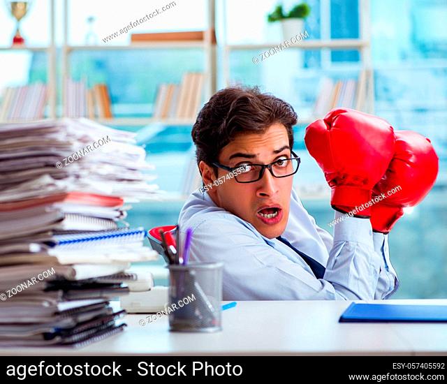 The businessman with boxing gloves in the office