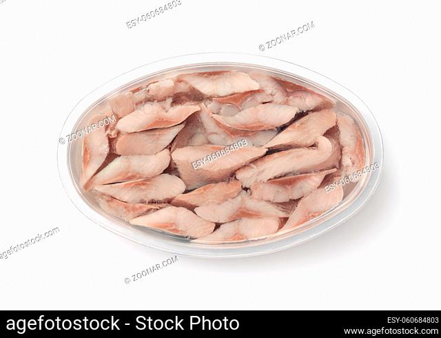 Top view of pickled herring in plastic container isolated on white