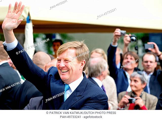 Dutch King Willem-Alexander waves to well-wisher visiting the Maczek monument in Warsaw, Poland, 24 June 2014. The king and queen are in Poland for their first...