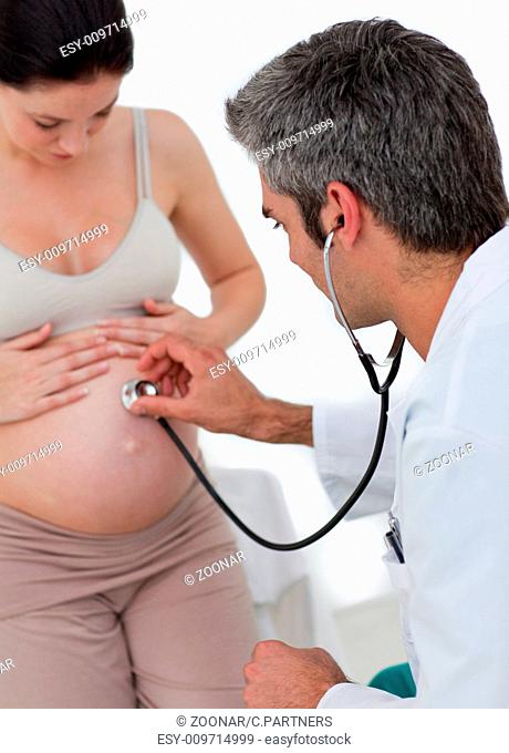 Beautiful pregnant woman examined by her gynecologist